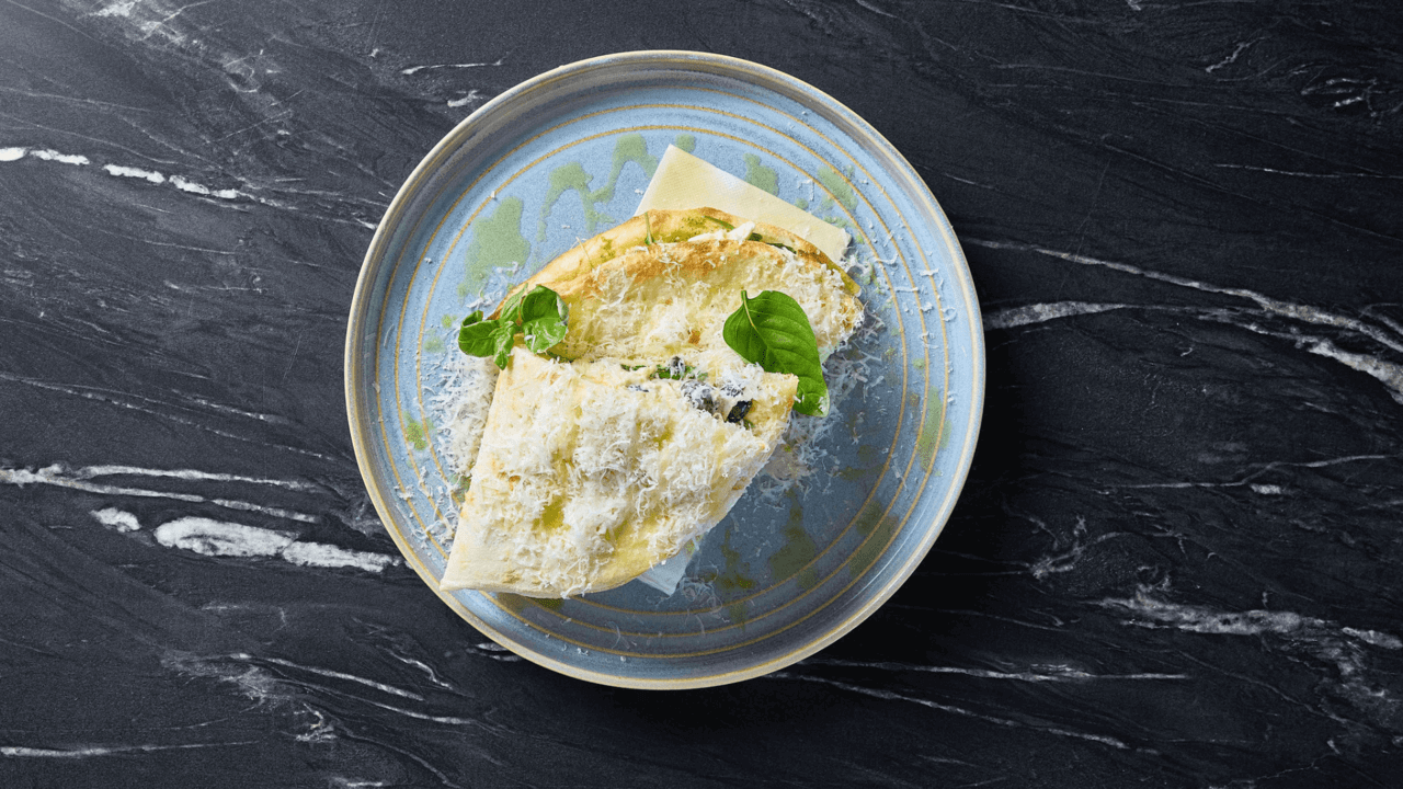 flatbread topped with mortadella, prosciutto, burrata, rocket, pesto and fresh tomato